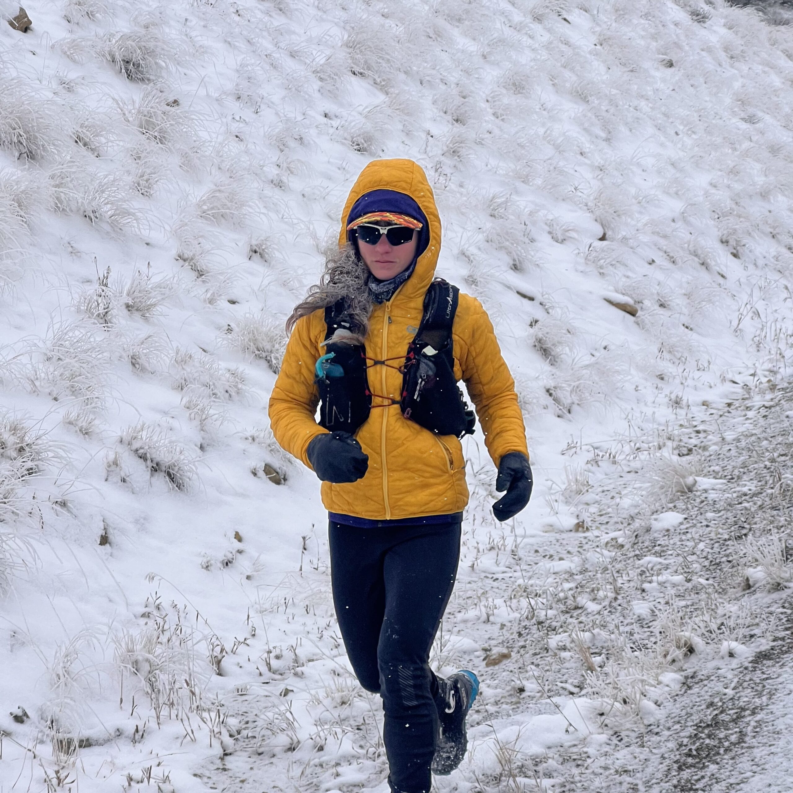 UltrAspire athlete Dandelion Dilluvio-Scott running snowy trails.